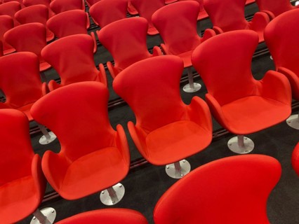 Red chairs in the press centre