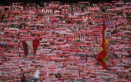 Fans hold up scarves