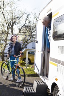 Subject: Pensioners with mountain bikes at their caravan