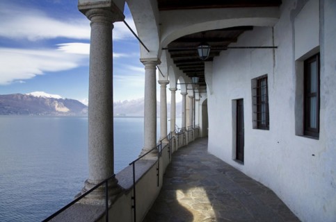 Eremo di Santa Caterina del Sasso on the Lake Maggiore with Snow-capped Mountain in Leggiuno in Lombardy