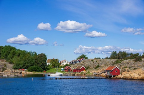 Picturesque rocky coast with small settlement and marina on an offshore island
