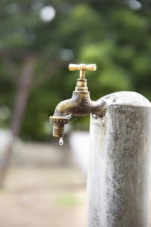 Water. Water bucket and dripping tap in Lome