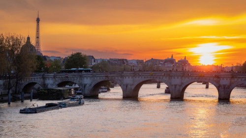 Sunset over the Seine in Paris with Pont Neuf bridge and Eiffel Tower