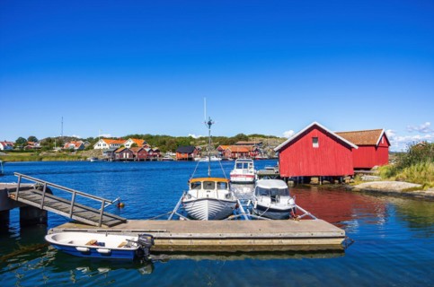 Mooring with boats and boathouses in the picturesque village of Langegaerde