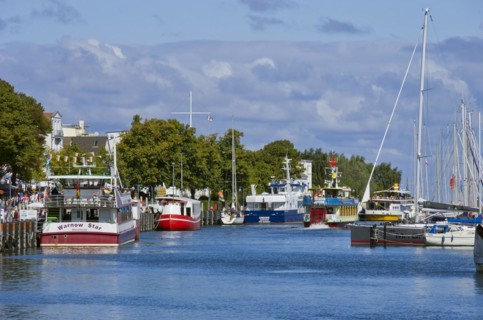 Fishing boats and excursion ships at the Alter Strom in Rostock-Warnemuende