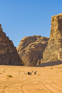 Bedouins with camels in desert