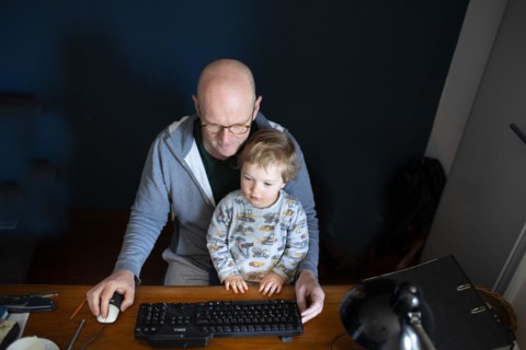 Man in home office and a small child
