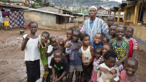 Old man with children in Bomeh Village at KissyRoad dumpsite