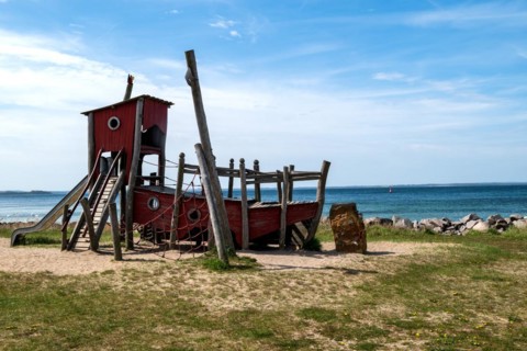 Climbing frame in the shape of a ship on a playground on the beach