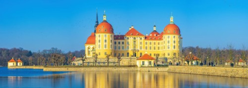 Exterior view of Moritzburg Castle in winter with half-frozen castle pond from the south