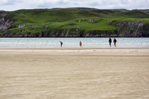Walkers on the sandy beach