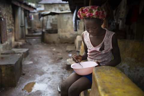Girl with a plate living in Bomeh Village at the KissyRoad dumpsite