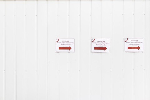 Three notices with the inscription 'Patients with cough