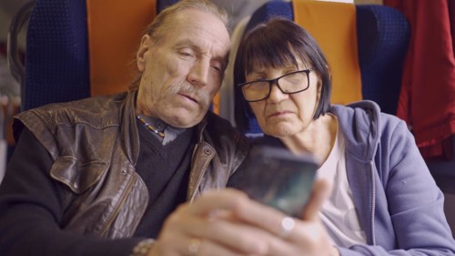 Elderly couple travel by train