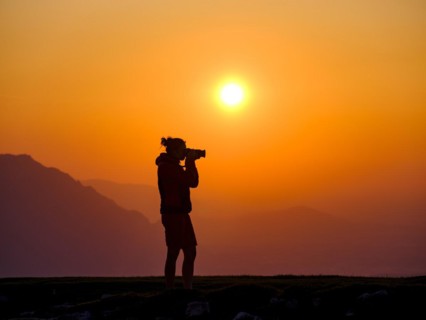 Silhouette of a photographer at sunset