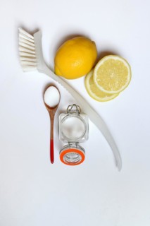 Citric acid in wooden spoon and glass container