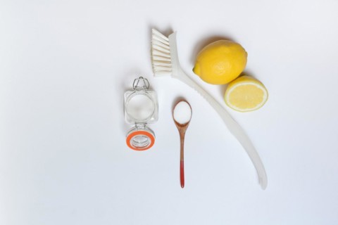 Citric acid in wooden spoon and glass container