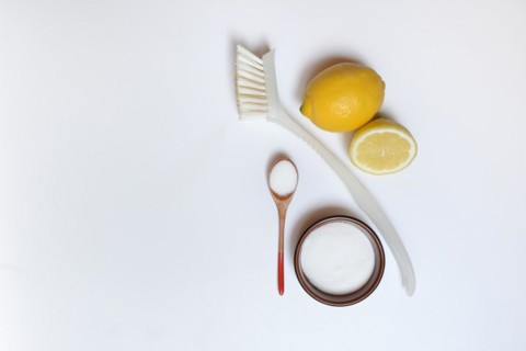 Citric acid in wooden spoon and small bowl