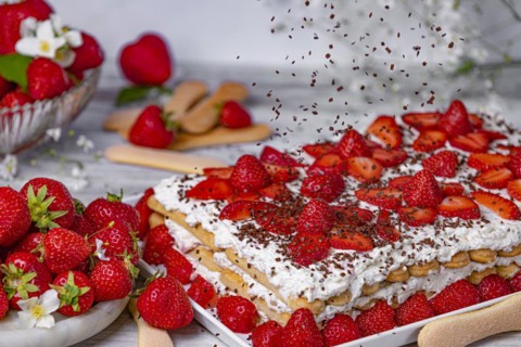 Tiramisu with strawberries and flying chocolate sprinkles
