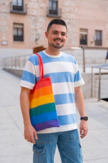 Portrait of gay man with a rainbow lgbt bag in the city