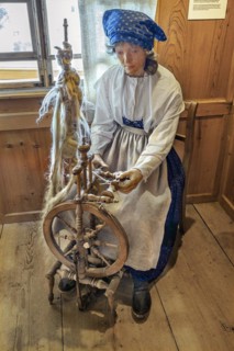 Figure of a flax spinner with spinning wheel