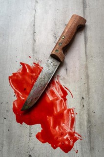 Bloody knife on a wooden table