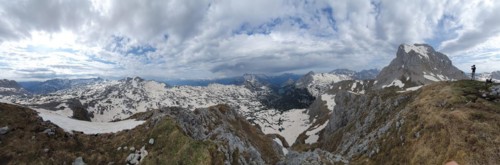 A hiker photographs the mountains of the Steinernes Meer in spring