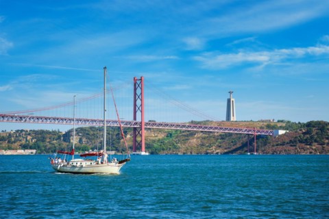 View of 25 de Abril Bridge famous tourist landmark over Tagus river