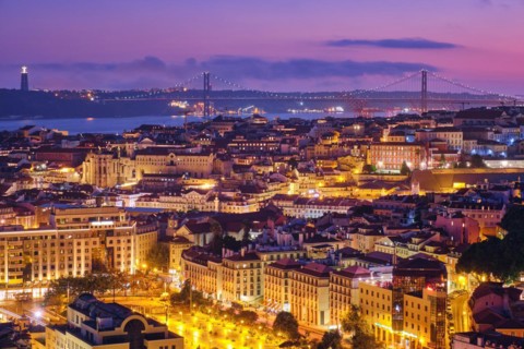 Night view of Lisbon famous view from Miradouro da Senhora do Monte tourist viewpoint of Alfama and Mauraria old city districts