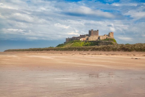 Flat sandy coast with Bamburgh Castle