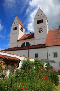 West façade with porch and monastery garden