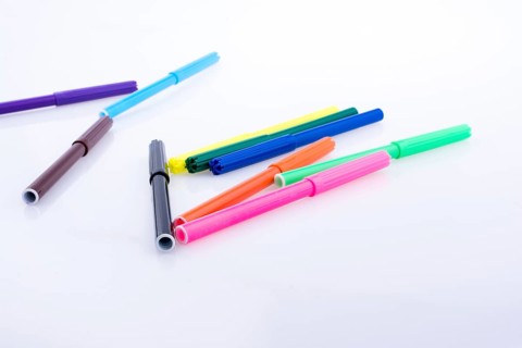 Color felt-tip pens of various color on white background