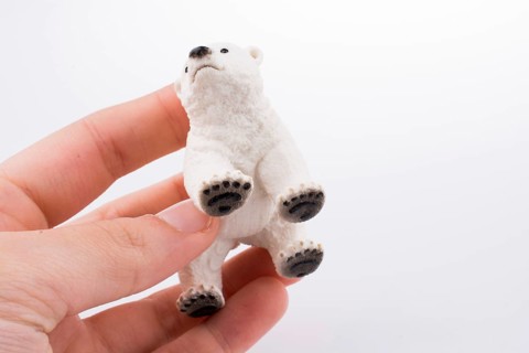 Hand holding White Polar bear model