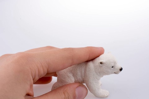 Hand holding White Polar bear model