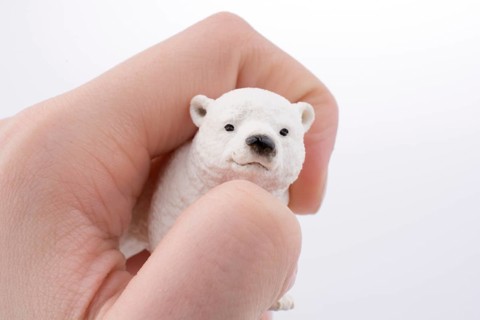 Hand holding White Polar bear model