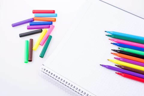 Colorful felt-tip pens on a notebook