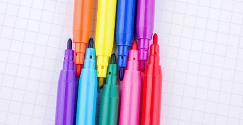 Colorful felt-tip pens on a notebook