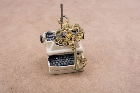 Retro syled tiny typewriter model on a white background