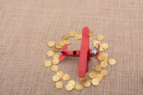 Fake gold coins around the retro model airplane