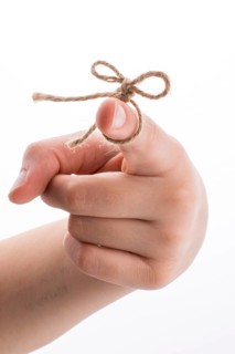 Hand tied with a thread like a ribbon on a white background