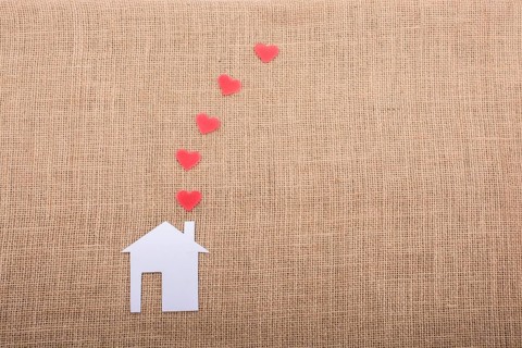 Heart shape coming out of chimney of paper house