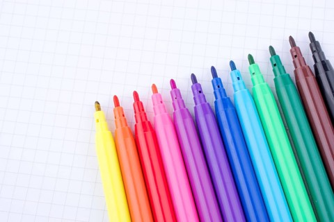 Colorful felt-tip pens on a notebook