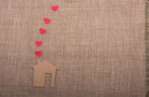 Heart shape coming out of chimney of paper house