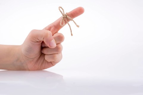 Hand tied with a thread like a ribbon on a white background