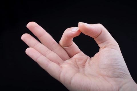 Hand gesturing sign ok okay agree on black background
