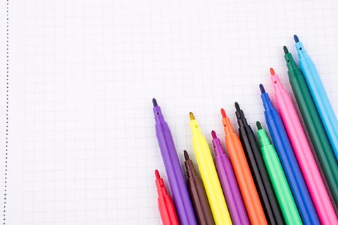 Colorful felt-tip pens on a notebook