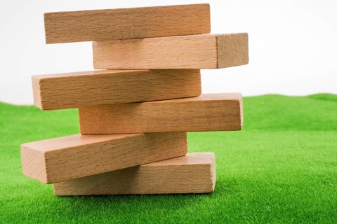 Wooden dominos on green grass