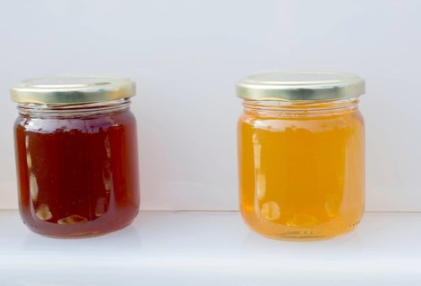 Glass jar of full of fresh honey with lid