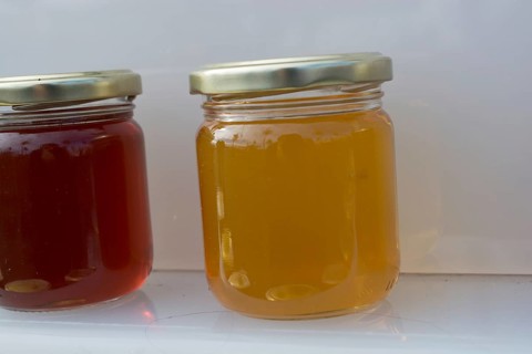 Glass jar of full of fresh honey with lid