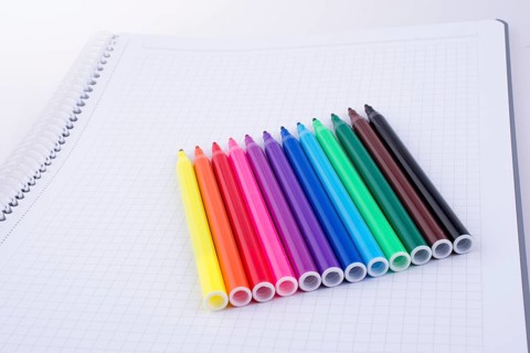 Colorful felt-tip pens on a notebook